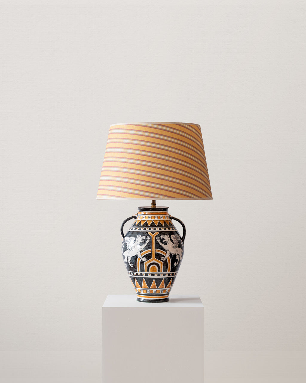 Decorative table lamp with a striped shade on a light gray background