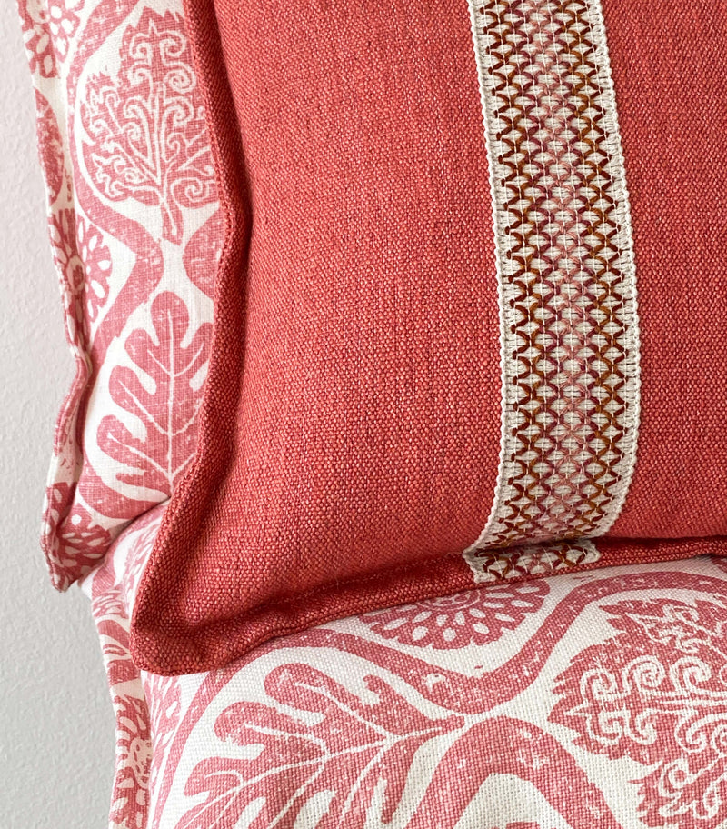 Pink cushion with braid with knife edge finish